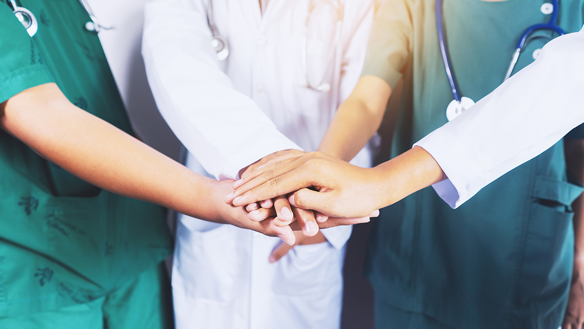 Addressing the Current Healthcare Staffing Crisis - health care workers holding hands