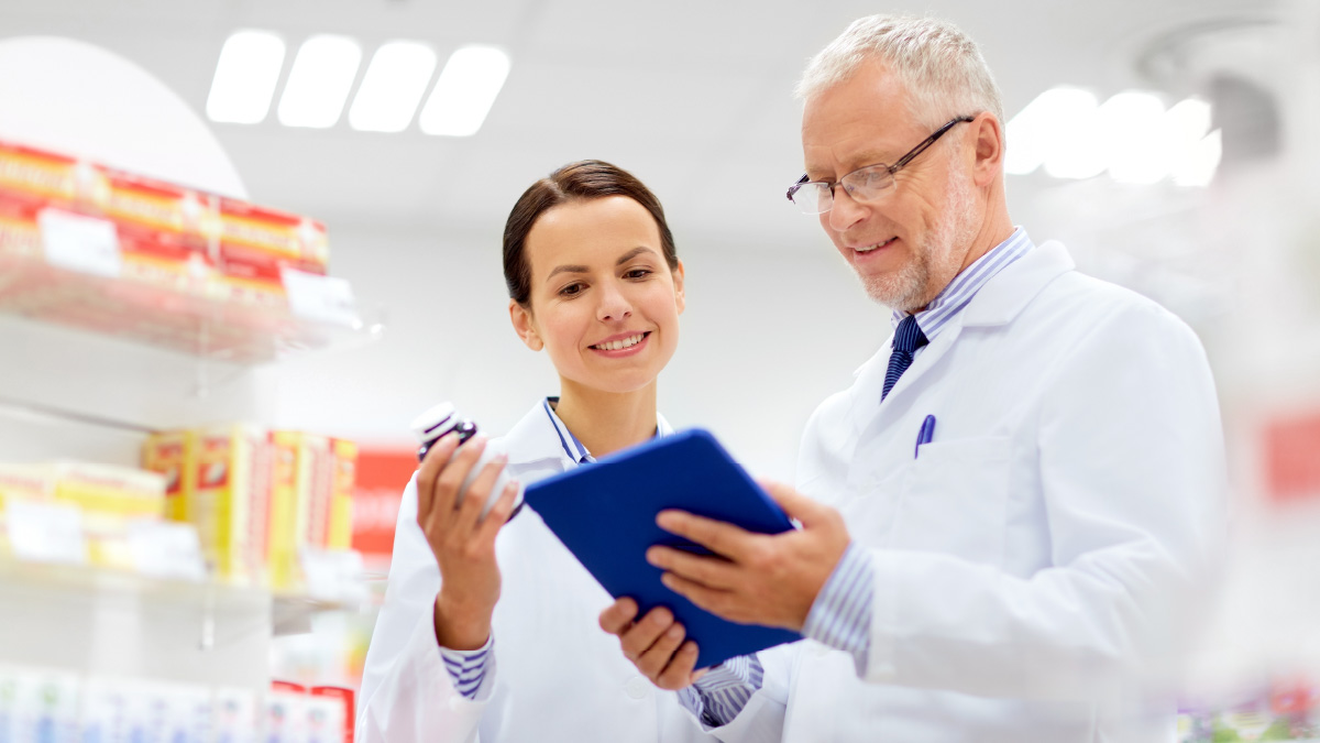 Pharmaceuticals Solutions - pharmacy workers looking at the prescription files